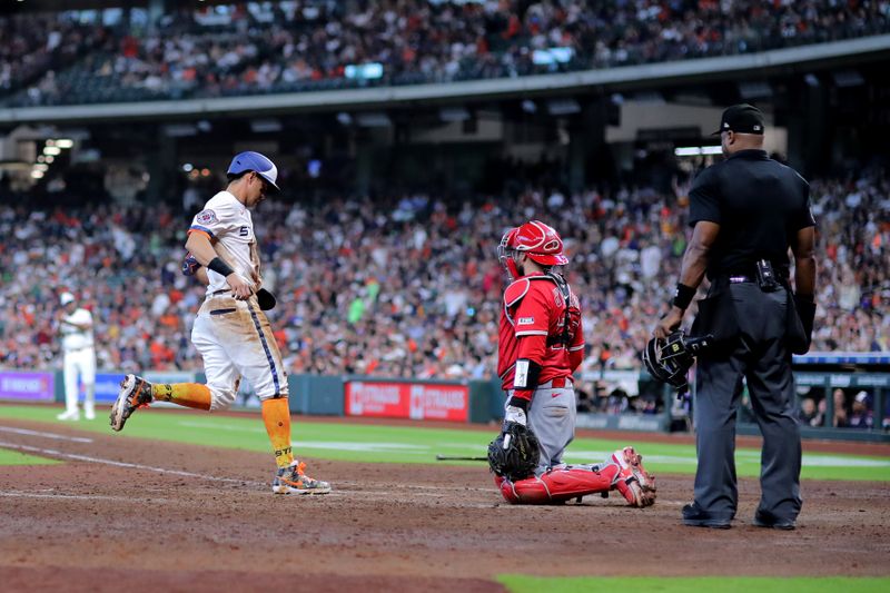 Apr 13, 2025; Houston, Texas, USA; Houston Astros second baseman Mauricio Dubón (14) crosses home plate to score  a run against the Los Angeles Angels during the seventh inning at Daikin Park. Mandatory Credit: Erik Williams-Imagn Images