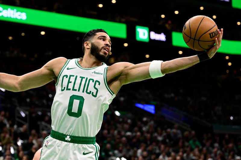 BOSTON, MASSACHUSETTS - JANUARY 10: Jayson Tatum #0 of the Boston Celtics rebounds the ball during the first half of a game against the Sacramento Kings at TD Garden on January 10, 2025 in Boston, Massachusetts.  NOTE TO USER: User expressly acknowledges and agrees that, by downloading and or using this photograph, User is consenting to the terms and conditions of the Getty Images License Agreement. (Photo by Billie Weiss/Getty Images)