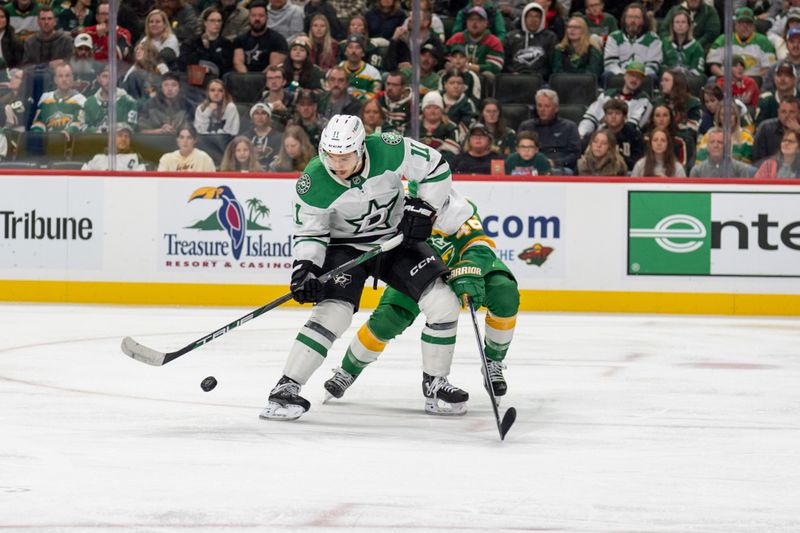 Nov 16, 2024; Saint Paul, Minnesota, USA; Dallas Stars center Logan Stankoven (11) controls the puck against Minnesota Wild defenseman Jared Spurgeon (46) in the third period at Xcel Energy Center. Mandatory Credit: Matt Blewett-Imagn Images