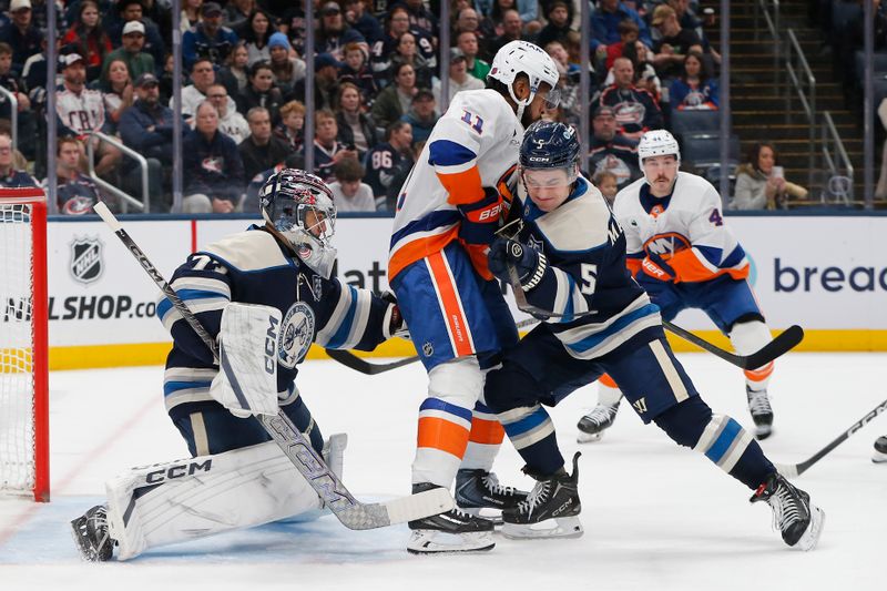 Dec 28, 2025; Columbus, Ohio, USA; Columbus Blue Jackets goalie Jet Greaves (73) makes a glove save as New York Islanders left wing Anthony Duclair (11) looks for a rebound during the first period at Nationwide Arena. Mandatory Credit: Russell LaBounty-Imagn Images