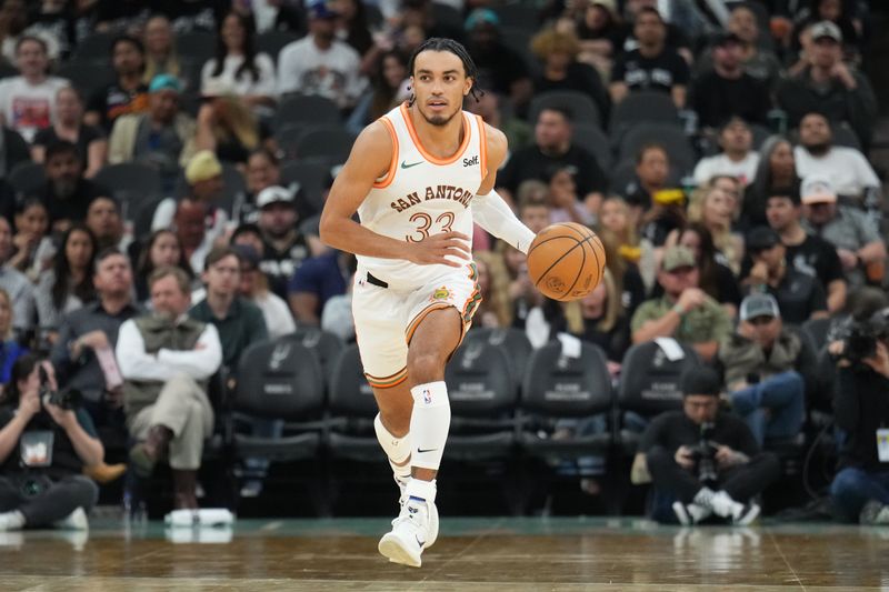 SAN ANTONIO, TX - MARCH 25: Tre Jones #33 of the San Antonio Spurs dribbles the ball during the game against the Phoenix Suns on March 25, 2024 at the AT&T Center in San Antonio, Texas. NOTE TO USER: User expressly acknowledges and agrees that, by downloading and or using this photograph, user is consenting to the terms and conditions of the Getty Images License Agreement. Mandatory Copyright Notice: Copyright 2024 NBAE (Photos by Jesse D. Garrabrant/NBAE via Getty Images)