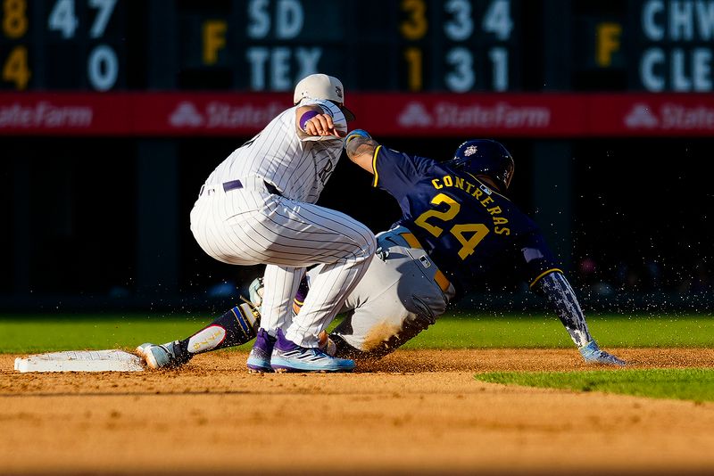 Jul 4, 2024; Denver, Colorado, USA; Milwaukee Brewers catcher William Contreras (24) slides into send base and is tagged out by Colorado Rockies shortstop Ezequiel Tovar (14) during the fifth inning at Coors Field. Mandatory Credit: Troy Babbitt-USA TODAY Sports

 