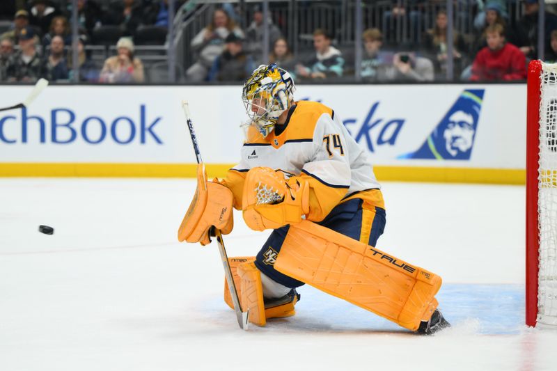 Jan 1, 2026; Seattle, Washington, USA; Nashville Predators goaltender Juuse Saros (74) blocks a goal shot against the Seattle Kraken during the second period at Climate Pledge Arena. Mandatory Credit: Steven Bisig-Imagn Images