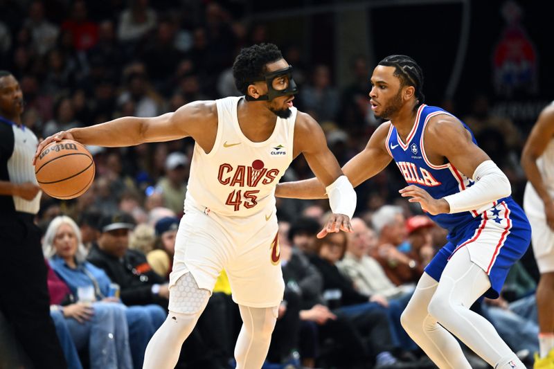 CLEVELAND, OHIO - MARCH 29: Donovan Mitchell #45 of the Cleveland Cavaliers faces off against Ricky Council IV #16 of the Philadelphia 76ers during the first half at Rocket Mortgage Fieldhouse on March 29, 2024 in Cleveland, Ohio. NOTE TO USER: User expressly acknowledges and agrees that, by downloading and or using this photograph, User is consenting to the terms and conditions of the Getty Images License Agreement. (Photo by Jason Miller/Getty Images)