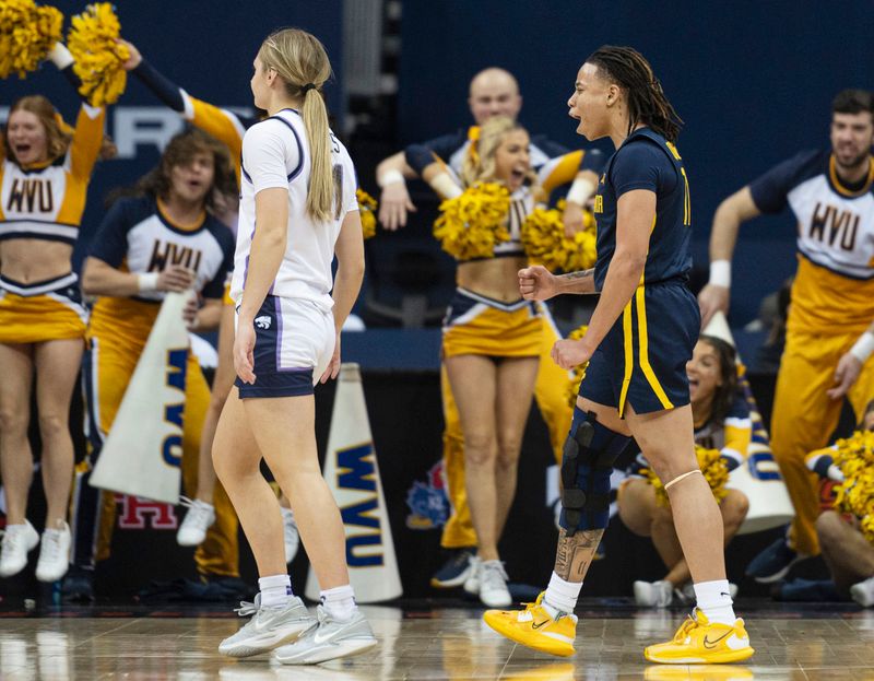 Mar 9, 2024; Kansas City, MO, USA; West Virginia Mountaineers guard JJ Quinerly (11) celebrates after making a basket against the Kansas State Wildcats during the second half at T-Mobile Center. Mandatory Credit: Amy Kontras-USA TODAY Sports