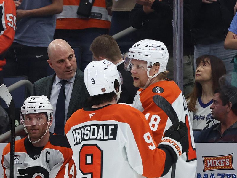 Nov 24, 2025; Tampa, Florida, USA; Philadelphia Flyers head coach Rick Tocchet talks with defenseman Jamie Drysdale (9) and center Rodrigo Abols (18) against the Tampa Bay Lightning during the second period at Benchmark International Arena. Mandatory Credit: Kim Klement Neitzel-Imagn Images