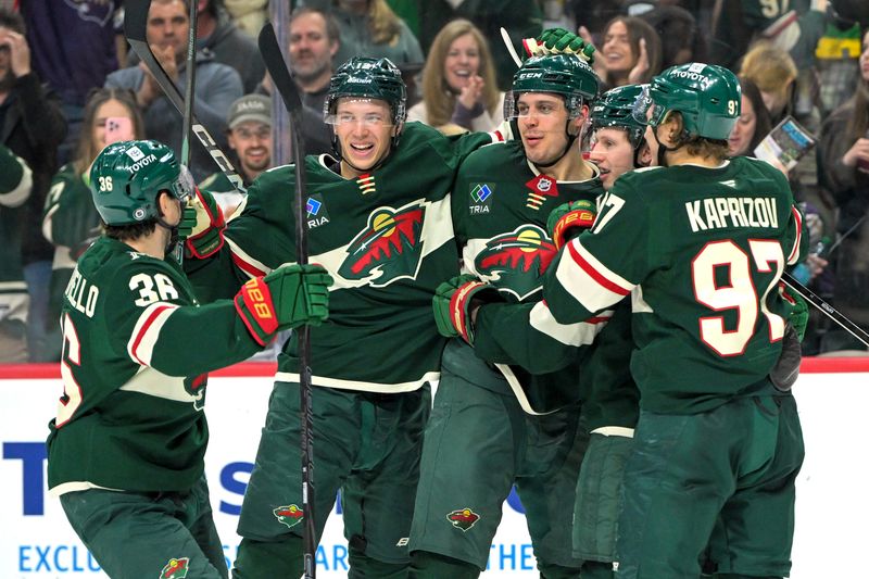 Apr 9, 2025; Saint Paul, Minnesota, USA;  Minnesota Wild forward Joel Eriksson Ek (14) celebrates with forward Mats Zuccarello (36), forward Joel Eriksson Ek (14), forward Marco Rossi (23) and forward Kiril Kaprizov (97) after completing a hat trick on a power play goal against the San Jose Sharks during the third period at Xcel Energy Center. Mandatory Credit: Nick Wosika-Imagn Images