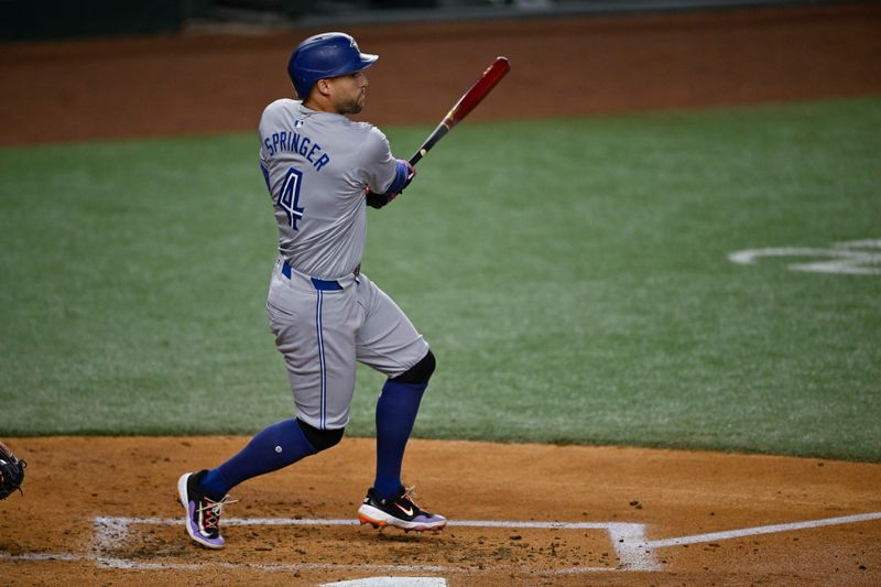 Sep 17, 2024; Arlington, Texas, USA; Toronto Blue Jays right fielder George Springer (4) hits a triple against the Texas Rangers during the second inning at Globe Life Field. Mandatory Credit: Jerome Miron-Imagn Images