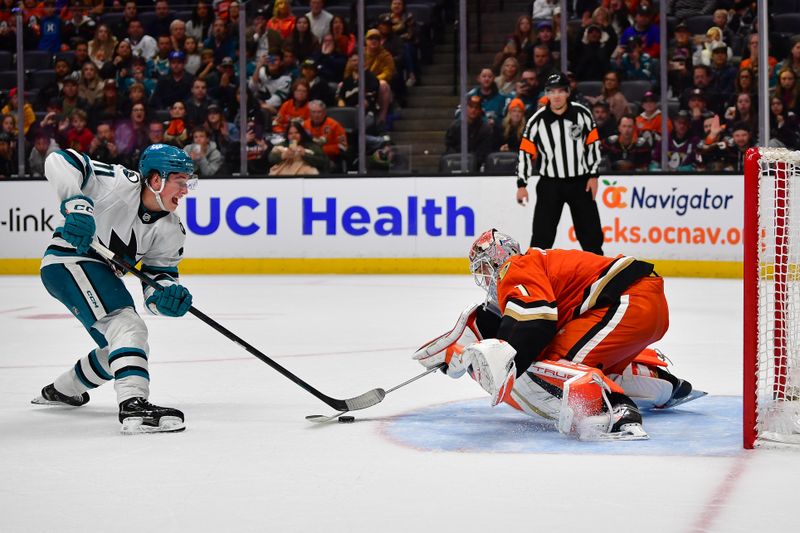 Apr 1, 2025; Anaheim, California, USA; Anaheim Ducks goaltender Lukas Dostal (1) blocks a shot against San Jose Sharks center Macklin Celebrini (71) during the shootout period at Honda Center. Mandatory Credit: Gary A. Vasquez-Imagn Images