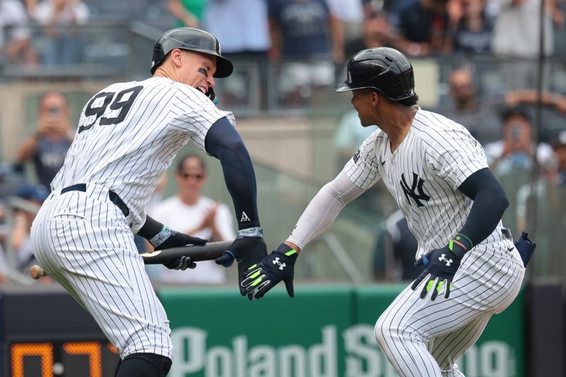 Aug 4, 2024; Bronx, New York, USA;  New York Yankees right fielder Juan Soto (22) celebrates his solo home run during the seventh inning against the Toronto Blue Jays with left fielder Aaron Judge (99) at Yankee Stadium. Mandatory Credit: Vincent Carchietta-USA TODAY Sports