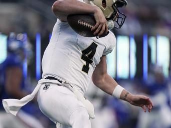 New Orleans Saints quarterback Derek Carr (4) escapes the tackle from New York Giants linebacker Brian Burns (0) during an NFL football game, Sunday, Nov. 17, 2024 in East Rutherford, N.J. The Saints defeated the Giants 14-11. (AP Photo/Vera Nieuwenhuis)