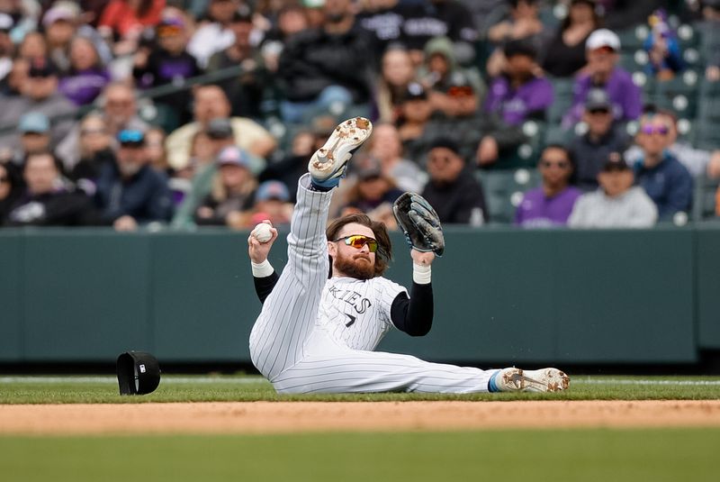 Apr 10, 2024; Denver, Colorado, USA; Colorado Rockies second baseman Brendan Rodgers (7) makes a throw to first from his back for an out in the sixth inning against the Arizona Diamondbacks at Coors Field. Mandatory Credit: Isaiah J. Downing-USA TODAY Sports