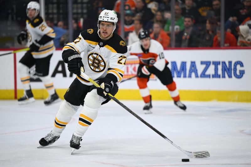 Nov 2, 2024; Philadelphia, Pennsylvania, USA; Boston Bruins defenseman Hampus Lindholm (27) controls the puck against the Philadelphia Flyers in the second period at Wells Fargo Center. Mandatory Credit: Kyle Ross-Imagn Images