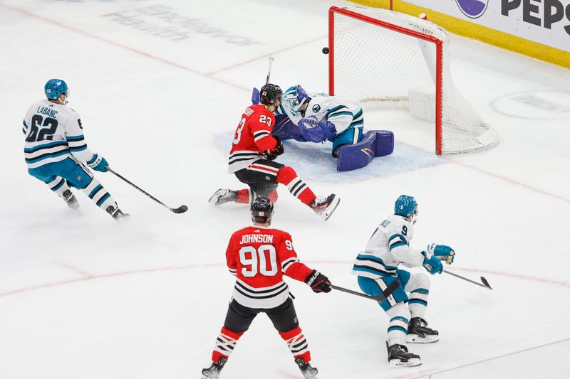 Mar 17, 2024; Chicago, Illinois, USA; Chicago Blackhawks center Philipp Kurashev (23) scores against the San Jose Sharks during the second period at United Center. Mandatory Credit: Kamil Krzaczynski-USA TODAY Sports