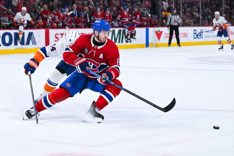 Mar 21, 2026; Montreal, Quebec, CAN; Montreal Canadiens defenseman Mike Matheson (8) defends the puck against New York Islanders center Bo Horvat (14) during the second period at Bell Centre. Mandatory Credit: David Kirouac-Imagn Images