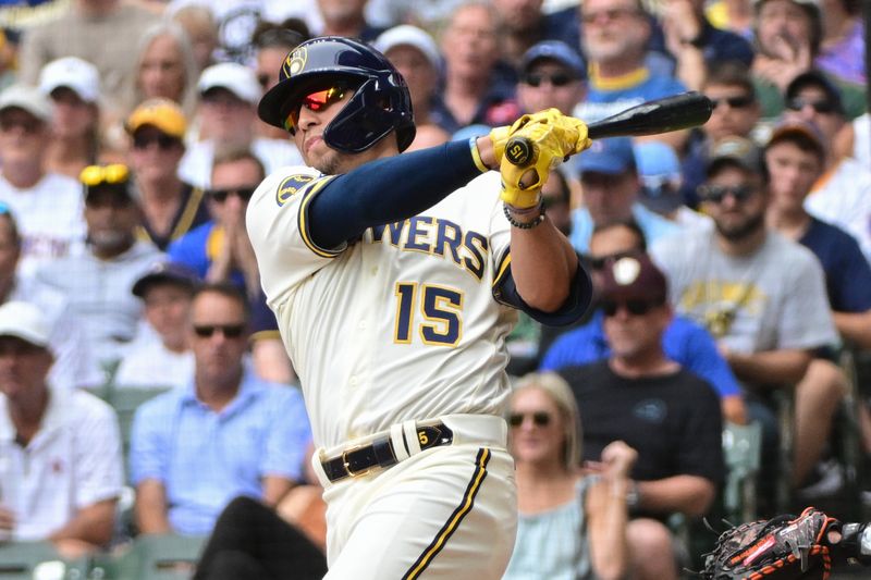 Aug 9, 2023; Milwaukee, Wisconsin, USA; Milwaukee Brewers left fielder Tyrone Taylor (15) hits a double to drive in two runs against the Colorado Rockies in the fourth inning at American Family Field. Mandatory Credit: Benny Sieu-USA TODAY Sports