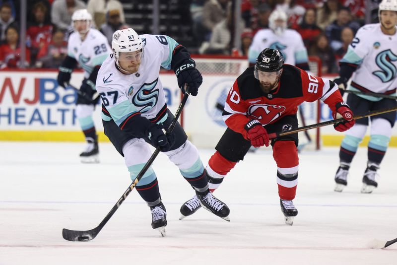 Dec 6, 2024; Newark, New Jersey, USA; Seattle Kraken center Mitchell Stephens (67) shoots the puck against the New Jersey Devils during the first period at Prudential Center. Mandatory Credit: Ed Mulholland-Imagn Images