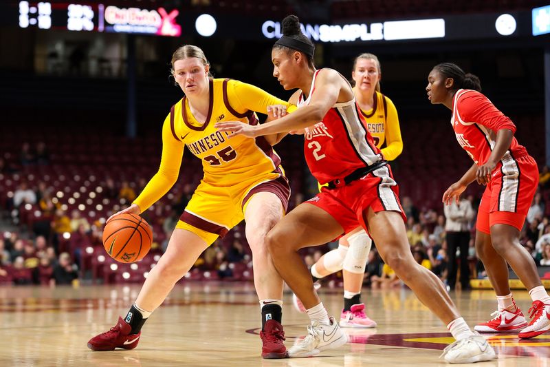 Feb 8, 2024; Minneapolis, Minnesota, USA; Minnesota Golden Gophers guard Grace Grocholski (25) dribbles as Ohio State Buckeyes guard Taylor Thierry (2) defends during the first half at Williams Arena. Mandatory Credit: Matt Krohn-USA TODAY Sports