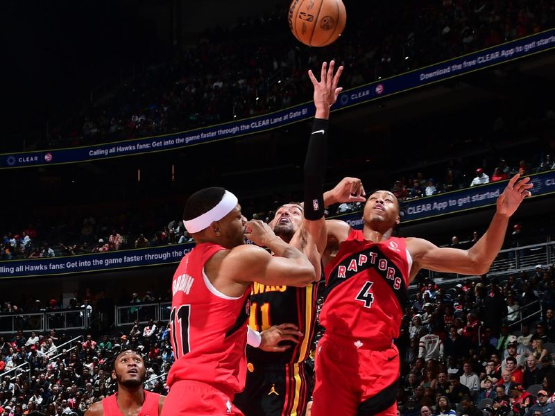 ATLANTA, GA - February 23:  Trae Young #11 of the Atlanta Hawks drives to the basket during the game against the Toronto Raptors on February 23, 2024 at State Farm Arena in Atlanta, Georgia.  NOTE TO USER: User expressly acknowledges and agrees that, by downloading and/or using this Photograph, user is consenting to the terms and conditions of the Getty Images License Agreement. Mandatory Copyright Notice: Copyright 2024 NBAE (Photo by Scott Cunningham/NBAE via Getty Images)