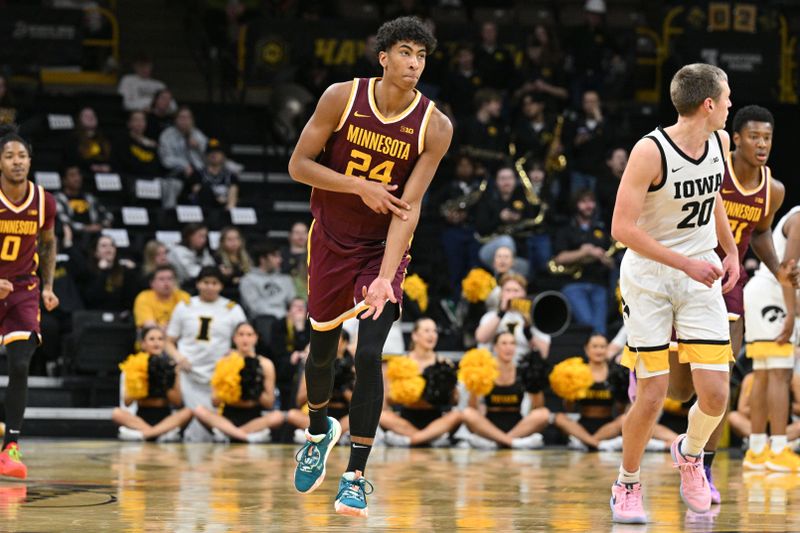 Feb 11, 2024; Iowa City, Iowa, USA; Minnesota Golden Gophers guard Braeden Carrington (4) reacts after a three point basket as Iowa Hawkeyes forward Payton Sandfort (20) looks on during the second half at Carver-Hawkeye Arena. Mandatory Credit: Jeffrey Becker-USA TODAY Sports