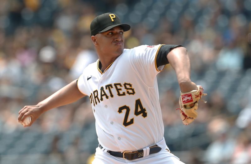 May 24, 2023; Pittsburgh, Pennsylvania, USA; Pittsburgh Pirates starting pitcher Johan Oviedo (24) delivers a pitch against the Texas Rangers during the first inning at PNC Park. Mandatory Credit: Charles LeClaire-USA TODAY Sports