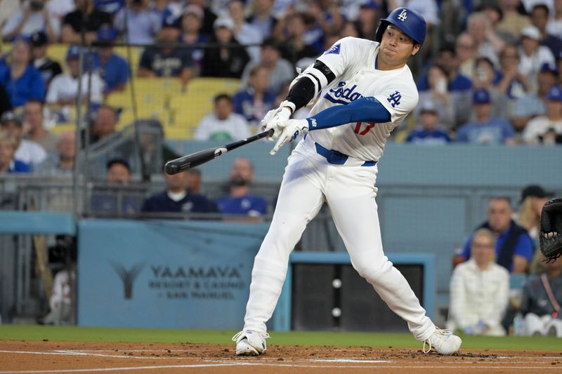 Aug 28, 2024; Los Angeles, California, USA;  Los Angeles Dodgers designated hitter Shohei Ohtani (17) hits a solo home run in the first inning against the Baltimore Orioles at Dodger Stadium. Mandatory Credit: Jayne Kamin-Oncea-USA TODAY Sports