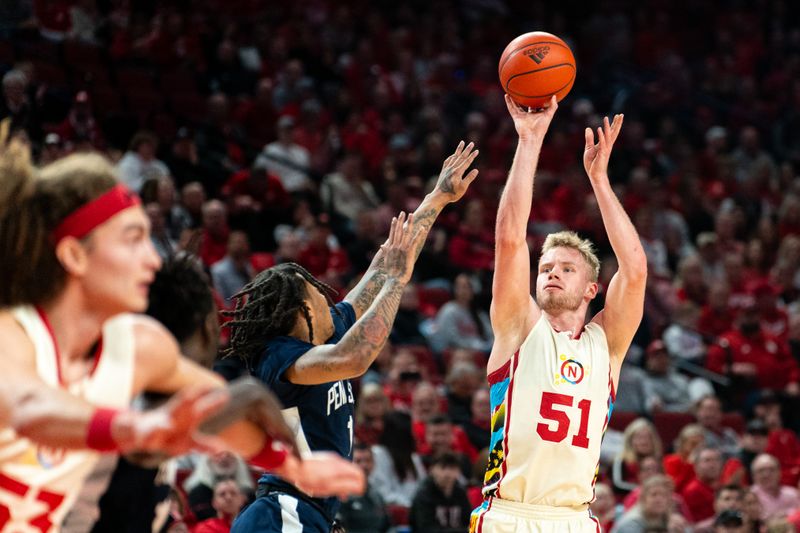 Feb 17, 2024; Lincoln, Nebraska, USA; Nebraska Cornhuskers forward Rienk Mast (51) shoots a 3-point shot against Penn State Nittany Lions guard Ace Baldwin Jr. (1) during the first half at Pinnacle Bank Arena. Mandatory Credit: Dylan Widger-USA TODAY Sports