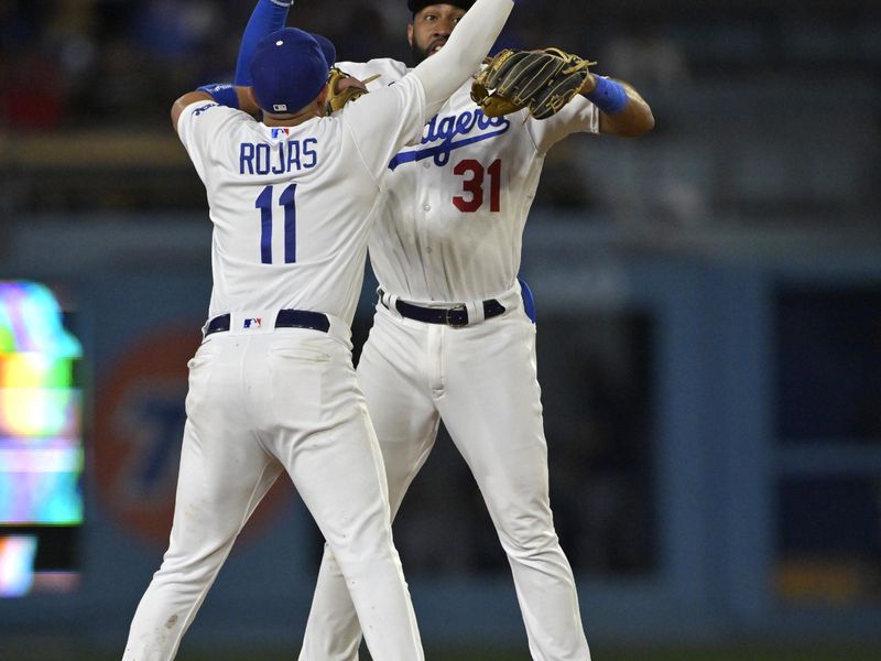 Aug 16, 2023; Los Angeles, California, USA;  Los Angeles Dodgers shortstop Miguel Rojas (11) and second baseman Amed Rosario (31) celebrate after the final out of the ninth inning against the Milwaukee Brewers at Dodger Stadium. Mandatory Credit: Jayne Kamin-Oncea-USA TODAY Sports