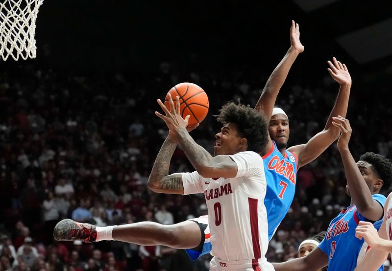 Jan 14, 2025; Tuscaloosa, AL, USA; Alabama guard Labaron Philon (0) goes into the lane for a shot against Ole Miss guard Davon Barnes (7) at Coleman Coliseum. Ole Miss defeated Alabama 74-64. Mandatory Credit: Gary Cosby Jr./USA TODAY Network via Imagn Images