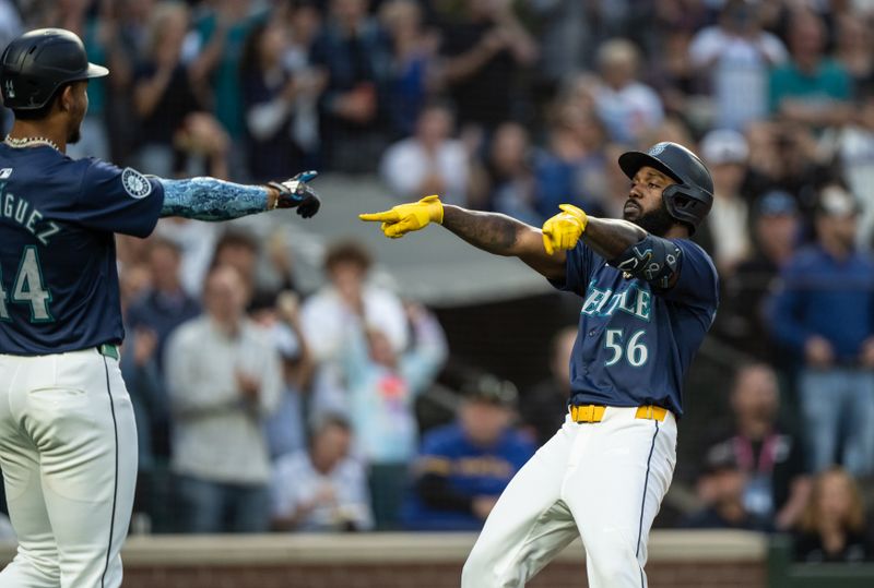 Aug 26, 2024; Seattle, Washington, USA; Seattle Mariners left fielder Randy Arozarena (56) celebrates with centerfielder Julio Rodriguez (44) after hitting aa three-run home run during the third inning against the Tampa Bay Rays at T-Mobile Park. Mandatory Credit: Stephen Brashear-USA TODAY Sports