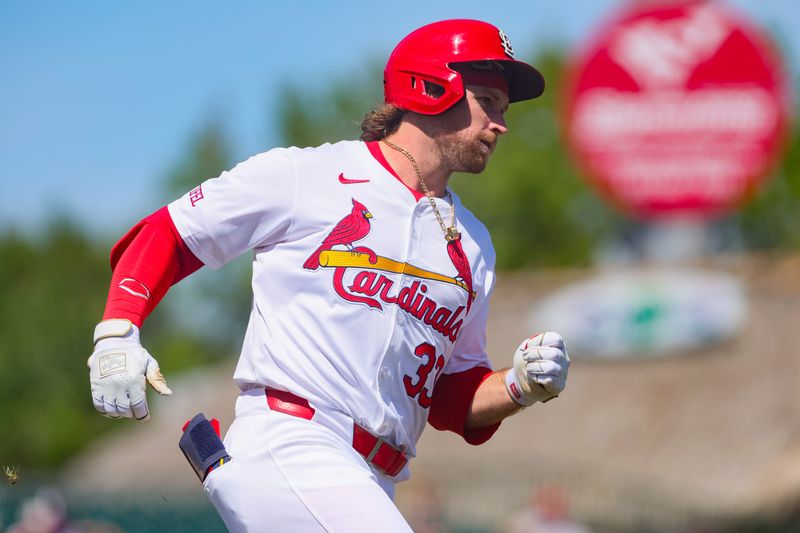 Mar 11, 2024; Jupiter, Florida, USA; St. Louis Cardinals second baseman Brendan Donovan (33) hits a single against the Washington Nationals during the first inning at Roger Dean Chevrolet Stadium. Mandatory Credit: Sam Navarro-USA TODAY Sports