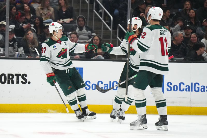 Apr 15, 2024; Los Angeles, California, USA; Minnesota Wild center Jacob Lucchini (27) celebrates with defenseman Zach Bogosian (24) and left wing Matt Boldy (12) after scoring a goal against the LA Kings in the third period at Crypto.com Arena. Mandatory Credit: Kirby Lee-USA TODAY Sports