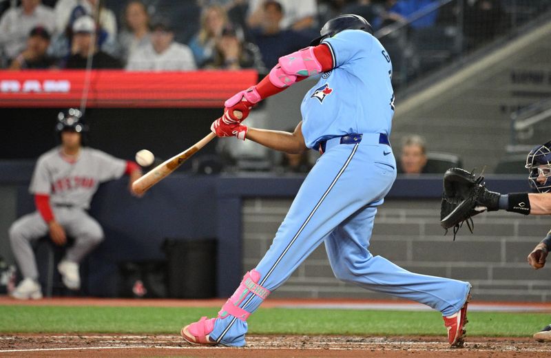 Sep 24, 2024; Toronto, Ontario, CAN; Toronto Blue Jays designated hitter Vladimir Guerrero Jr. (27) hits a two run RBI double against the Boston Red Sox in the third inning at Rogers Centre. Mandatory Credit: Dan Hamilton-Imagn Images