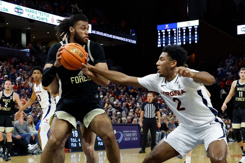 Feb 17, 2024; Charlottesville, Virginia, USA; Wake Forest Demon Deacons forward Efton Reid III (4) drives to the basket as Virginia Cavaliers guard Reece Beekman (2) defends in the first half at John Paul Jones Arena. Mandatory Credit: Geoff Burke-USA TODAY Sports