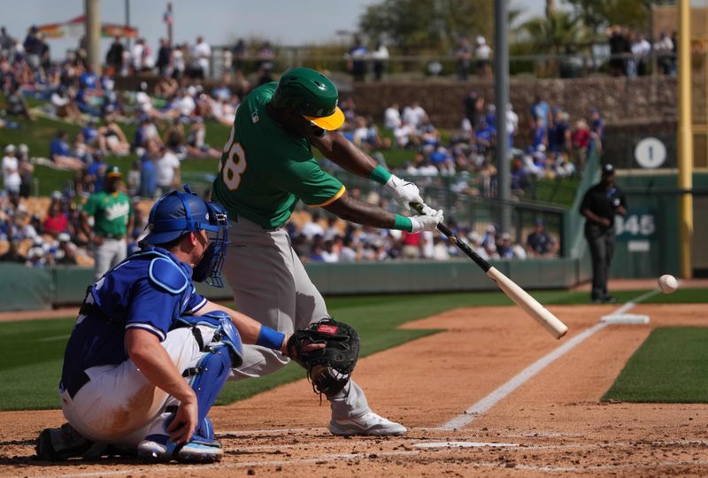 Feb 25, 2024; Phoenix, Arizona, USA; Oakland Athletics right fielder Daz Cameron bats against the Los Angeles Dodgers during the second inning at Camelback Ranch-Glendale. Mandatory Credit: Joe Camporeale-USA TODAY Sports