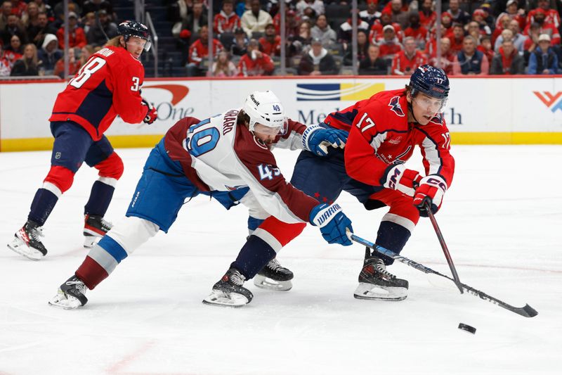 Feb 13, 2024; Washington, District of Columbia, USA; Washington Capitals center Dylan Strome (17) and Colorado Avalanche defenseman Samuel Girard (49) battle for the puck in the first period at Capital One Arena. Mandatory Credit: Geoff Burke-USA TODAY Sports