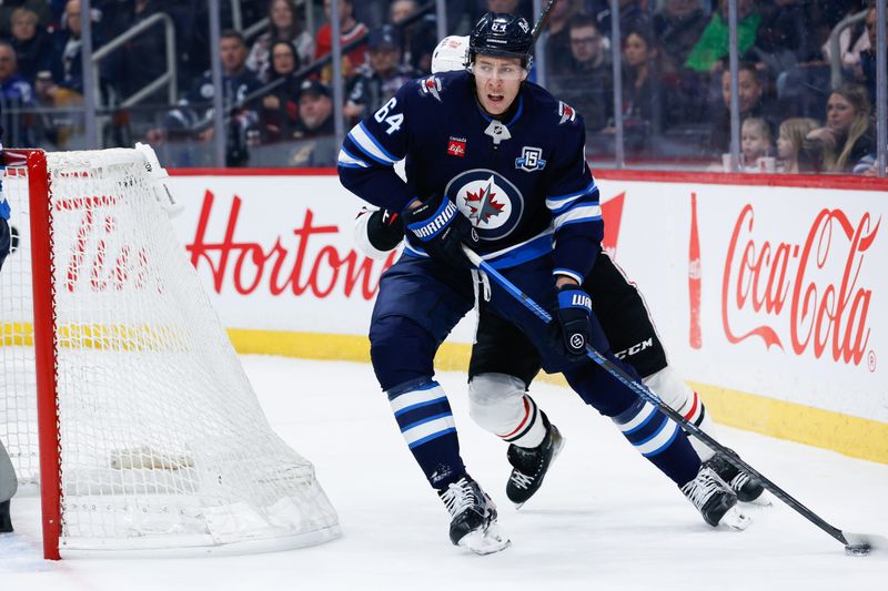 Mar 3, 2026; Winnipeg, Manitoba, CAN;  Winnipeg Jets defenseman Logan Stanley (64) skates away from Chicago Blackhawks defenseman Artyom Levshunov (55) during the first period at Canada Life Centre. Mandatory Credit: Terrence Lee-Imagn Images