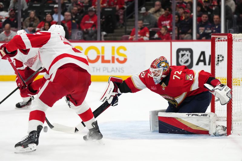 Jan 17, 2024; Sunrise, Florida, USA; Florida Panthers goaltender Sergei Bobrovsky (72) knocks the puck away from Detroit Red Wings left wing J.T. Compher (37) during the first period at Amerant Bank Arena. Mandatory Credit: Jasen Vinlove-USA TODAY Sports