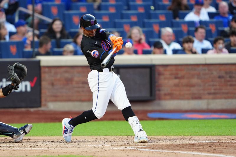 May 31, 2024; New York City, New York, USA; New York Mets shortstop Francisco Lindor (12) hits an RBI double against the Arizona Diamondbacks during the second inning at Citi Field. Mandatory Credit: Gregory Fisher-USA TODAY Sports