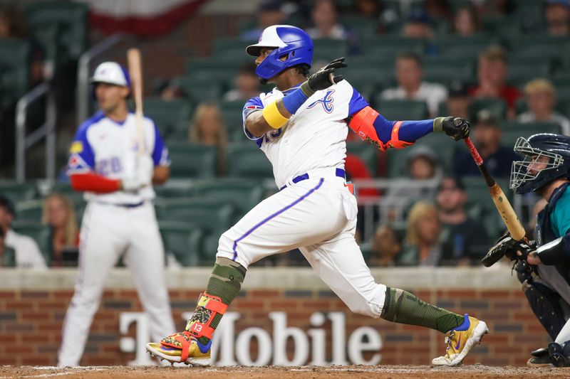 May 20, 2023; Atlanta, Georgia, USA; Atlanta Braves right fielder Ronald Acuna Jr. (13) hits a single against the Seattle Mariners in the eighth inning at Truist Park. Mandatory Credit: Brett Davis-USA TODAY Sports
