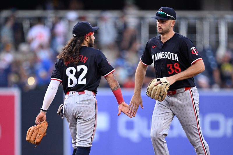 Aug 21, 2024; San Diego, California, USA; Minnesota Twins right fielder Matt Wallner (38) and left fielder Austin Martin (82) celebrate on the field after defeating the San Diego Padres at Petco Park. Mandatory Credit: Orlando Ramirez-USA TODAY Sports
