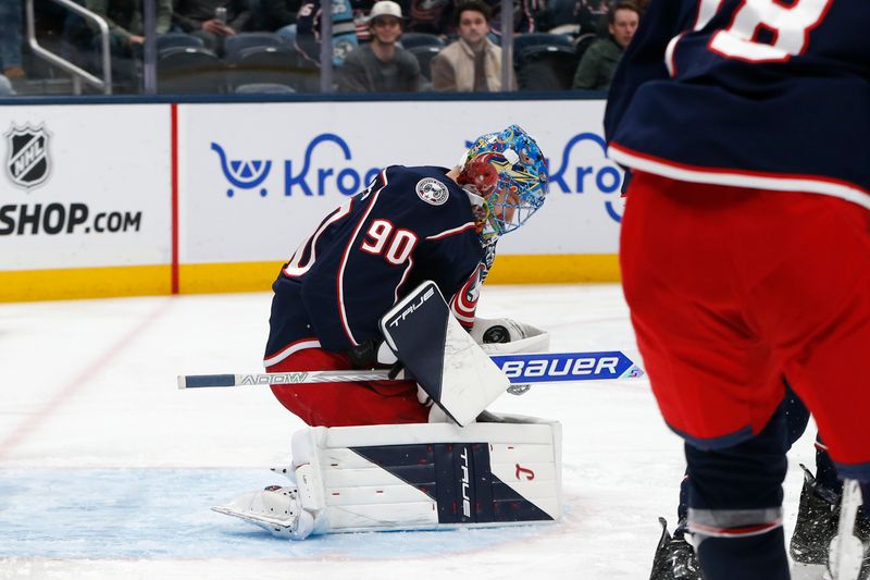 Jan 20, 2026; Columbus, Ohio, USA; Columbus Blue Jackets goalie Elvis Merzlikins (90) makes a glove save against the Ottawa Senators during the first period at Nationwide Arena. Mandatory Credit: Russell LaBounty-Imagn Images