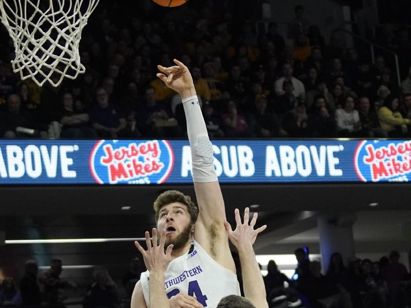 Feb 19, 2023; Evanston, Illinois, USA;Northwestern Wildcats center Matthew Nicholson (34) shoots over Iowa Hawkeyes forward Filip Rebraca (0) during the second half at Welsh-Ryan Arena. Mandatory Credit: David Banks-USA TODAY Sports