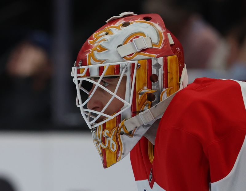 Oct 15, 2025; Salt Lake City, Utah, USA;  Calgary Flames goaltender Devin Cooley (1) watches play against the Utah Mammoth during the first period at Delta Center. Mandatory Credit: Rob Gray-Imagn Images