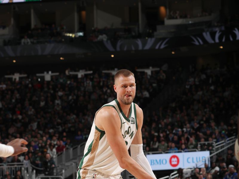 MILWAUKEE, WI - JANUARY 11:  Kristaps Porzingis #8 of the Boston Celtics handles the ball during the game  on January 11, 2024 at the Fiserv Forum Center in Milwaukee, Wisconsin. NOTE TO USER: User expressly acknowledges and agrees that, by downloading and or using this Photograph, user is consenting to the terms and conditions of the Getty Images License Agreement. Mandatory Copyright Notice: Copyright 2024 NBAE (Photo by Gary Dineen/NBAE via Getty Images).