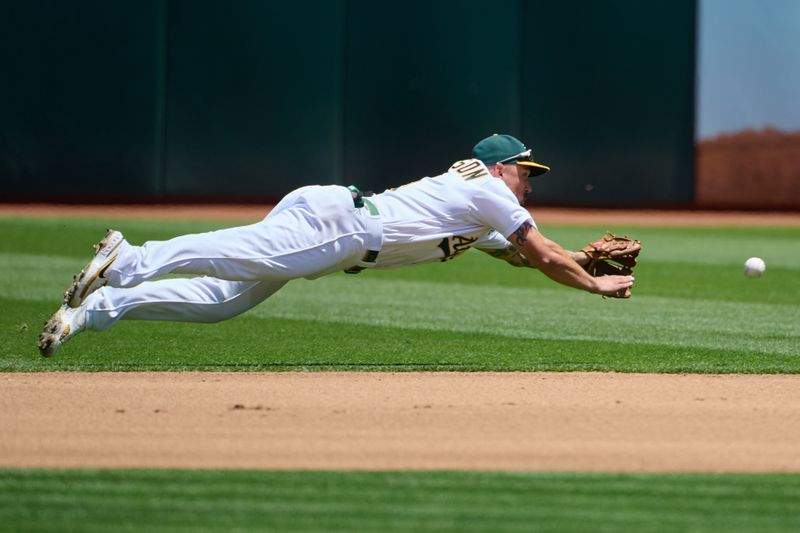 Jun 17, 2023; Oakland, California, USA; Oakland Athletics infielder Jace Peterson (6) dives for a ground ball against the Philadelphia Phillies during the fourth inning at Oakland-Alameda County Coliseum. Mandatory Credit: Robert Edwards-USA TODAY Sports