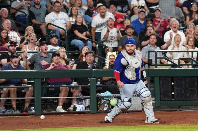 Jul 13, 2024; Phoenix, Arizona, USA; Toronto Blue Jays catcher Alejandro Kirk (30) reacts after misplaying a foul pop against the Arizona Diamondbacks during the fifth inning at Chase Field. Mandatory Credit: Joe Camporeale-USA TODAY Sports