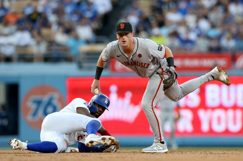 Jul 23, 2024; Los Angeles, California, USA; San Francisco Giants outfielder Tyler Fitzgerald (49) looks to first after forcing out Los Angeles Dodgers outfielder Jason Heyward (23) during the second inning at Dodger Stadium. Mandatory Credit: Jason Parkhurst-USA TODAY Sports