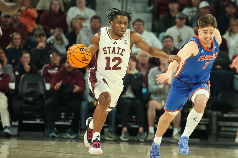 Feb 11, 2025; Starkville, Mississippi, USA; Mississippi State Bulldogs guard Josh Hubbard (12) drives against Florida Gators guard Urban Klavzar (7) during the second half at Humphrey Coliseum. Mandatory Credit: Wesley Hale-Imagn Images