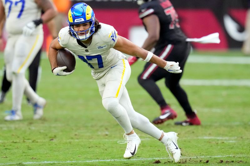 Los Angeles Rams wide receiver Puka Nacua runs with the ball against the Arizona Cardinals during the second half of an NFL football game Sunday, Nov. 26, 2023, in Glendale, Ariz. The Rams won 37-14. (AP Photo/Ross D. Franklin)